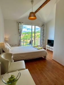 a bedroom with a bed and a large window at Villa Chingo in Ohrid