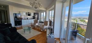 a living room with a view of a kitchen at Mr.-Legend's Penthouse in Skopje