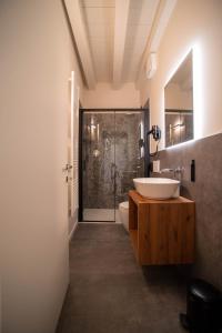 a bathroom with a sink and a toilet and a shower at Calcirelli Suites in Verona