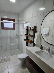 a bathroom with a toilet and a sink and a shower at Leo’s Gasthaus in São Vendelino