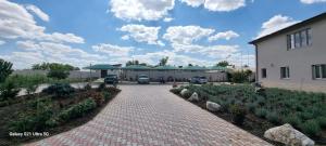 a driveway leading to a building with cars parked at Hotel Lavanda in Piteasca
