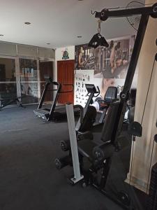 a gym with several tread machines in a room at Loft Centro - No Calçadão e em frente Parque das Águas in São Lourenço