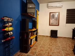 a living room with a blue wall and a tile floor at Casa Azul in La Paz