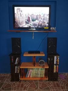 a flat screen tv sitting on a wall with speakers at Casa Azul in La Paz