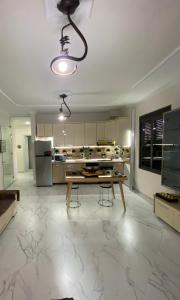 a large kitchen with a wooden table and a kitchen with a refrigerator at Apartment in Golem
