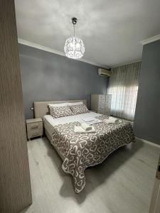 a bedroom with a bed and a chandelier at Apartment in Golem