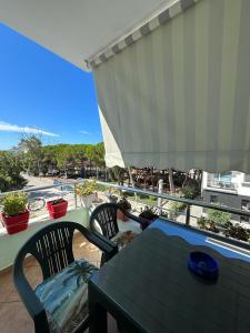 a balcony with a table and chairs and a view of the ocean at Apartment in Golem
