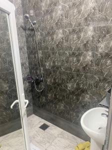 a bathroom with a shower and a sink at Hotel City Rooms Prishtina in Pristina