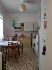 a kitchen with a table and a table and chairs at Retro comfy home near Monastiraki in Athens