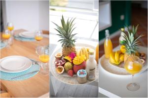 a table with a plate of fruit and glasses of orange juice at Duplex de Malendure in Bouillante