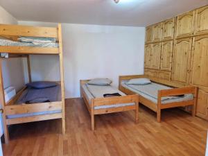 two bunk beds in a room with wooden cabinets at Cabana Muntelui in Cluj-Napoca