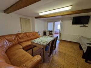 a living room with a couch and a table at Cabana Muntelui in Cluj-Napoca