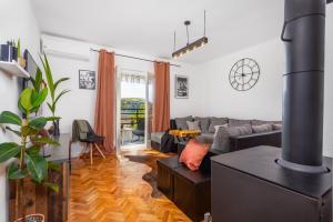 a living room with a couch and a fireplace at Apartment "CAROVO 7" in Kraljevica