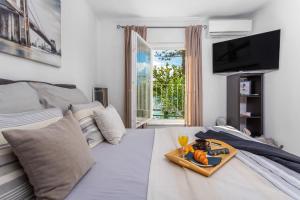 a room with a bed with a tray of food on it at Apartment "CAROVO 7" in Kraljevica