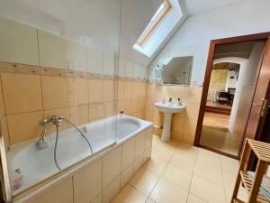 a bathroom with a tub and a sink at Central Apartment Fun & Teambuilding in Košice +24 photos