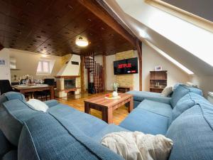 a living room with a blue couch and a table at Central Apartment Fun & Teambuilding in Košice