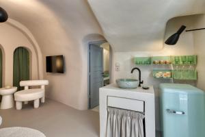 a bathroom with a sink and a toilet at Hermes Cave House by Oias Local Cave Houses in Oia