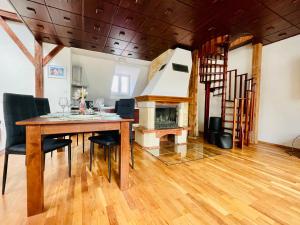 a dining room with a table and a fireplace at Central Apartment Fun & Teambuilding in Košice