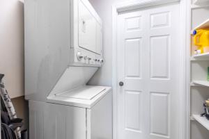 a white laundry room with a sink and a white door at Escape to Our Private Guest House in Jupiter Farms in Jupiter