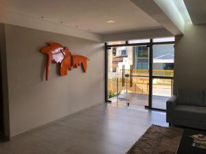 a living room with a wall with a fox sculpture on the wall at Flat Versatti - Próximo Real Hospital Port e Pólo Médico Ilha do Leite in Recife