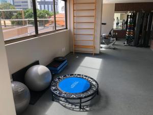 a room with a gym with a large window at Flat Versatti - Próximo Real Hospital Port e Pólo Médico Ilha do Leite in Recife