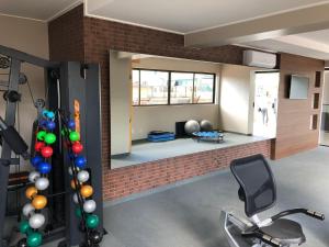 a room with a gym with a mirror and a chair at Flat Versatti - Próximo Real Hospital Port e Pólo Médico Ilha do Leite in Recife