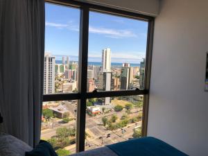 a view of a city from a bedroom window at Flat Versatti - Próximo Real Hospital Port e Pólo Médico Ilha do Leite in Recife