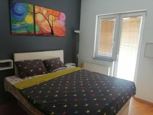 a bedroom with a bed and a painting on the wall at Dream S in Niš