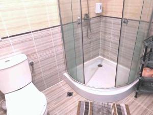 a bathroom with a shower and a toilet at Sunrise Studio Grenada in Sunny Beach