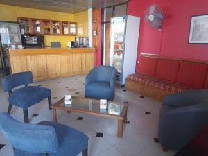 a waiting room with blue chairs and a table at Bari in Mendoza