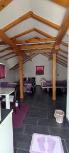 a living room with purple furniture and wooden ceilings at Melissa 1Apartman in Rakovica