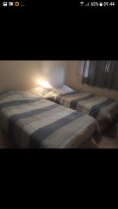 two beds sitting next to each other in a bedroom at Casa REYES JUJUY in Reyes