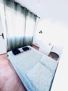 a bedroom with two beds and a window at Chambres à louer dans appartement in Montpellier