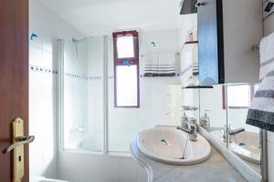 a white bathroom with a sink and a shower at Terrace to Atlantic in Santa Cruz +44 photos