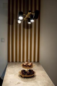 a table with two plates of donuts in a room at Legato Apartment in Brčko