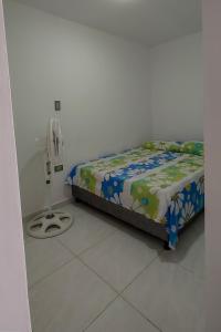 a bedroom with a bed and a fan at Apartamentos amoblados Margaritas in Ríohacha