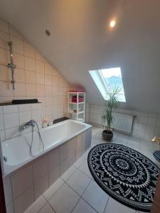 a large bathroom with a tub and a potted plant at Ferienwohnung mit Weitblick in Nordhessen in Gudensberg