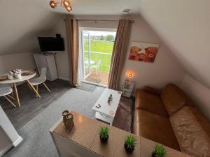 a living room with a couch and a table at Vicki's Den in Tain