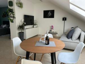 a living room with a table and a couch at LEO Apartment FREE PARKING - President Palace in Bratislava