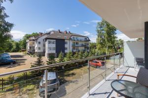 an apartment balcony with a view of a parking lot at Apartament Baltic&SPA - Aprent in Międzywodzie