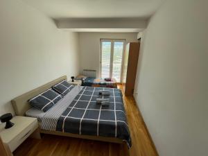 a bedroom with a large bed in a room at Big Apartment with private parking - EXTRA VIEW in Skopje