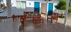 a porch with two chairs and a swing at Ariena in Los Órganos