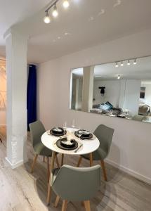 a dining room with a white table and chairs at Home Inn Apartments - 201 in Minden