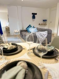 a living room with a table with glasses and a couch at Home Inn Apartments - 201 in Minden +10 photos