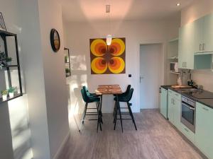 a kitchen with a table and chairs in a room at Royal South - Apartment Antwerp with Parkview in Antwerp