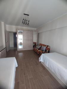 a living room with two beds and a couch at الداون تاون العالمين الجديدة خلف الابراج_ElDown Town New alameim in El Alamein