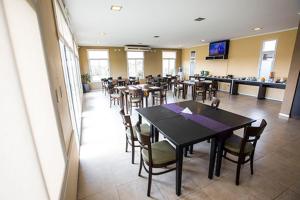 a dining room with tables and chairs in a restaurant at LS Hotel in Salta