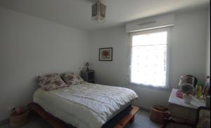 1 dormitorio con cama y ventana en Chambre chez l'habitant "Entre Airs et Montagnes", en Tallard