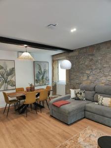 a living room with a couch and a table at Brand new Port Relax with AC by Santiago in San Sebastián