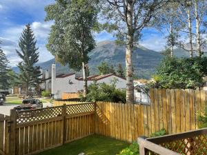 a wooden fence with mountains in the background at Cedar House in Jasper